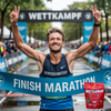 SportBrennstoff Wettkampf - Optimale Energie für Spitzenleistungen: Ein Marathonläufer jubelt beim Zieleinlauf, daneben das Pulverprodukt für Sporternährung. Ideal für intensive Wettkämpfe mit 120g Kohlenhydraten pro Stunde.